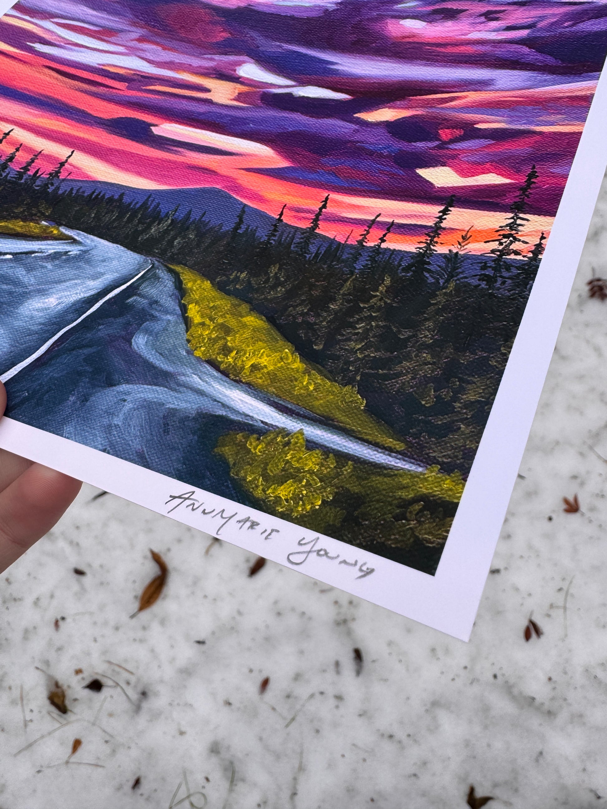 A print of a painting depicting a sunset over an Alaskan road. Colorful landscape painting signed by AnnMarie Young